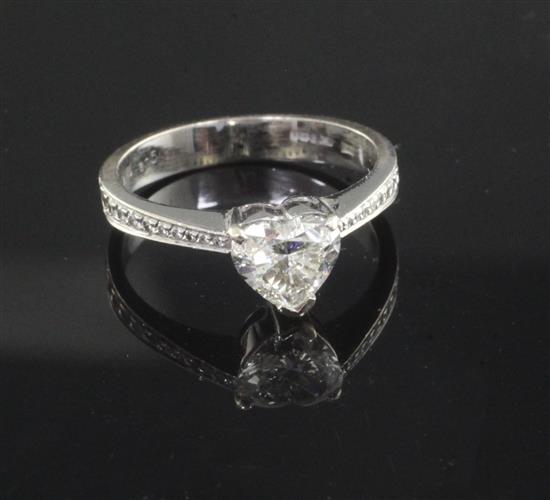 A modern 18ct white gold and single stone heart shaped diamond ring, with diamond set shoulders, size M.